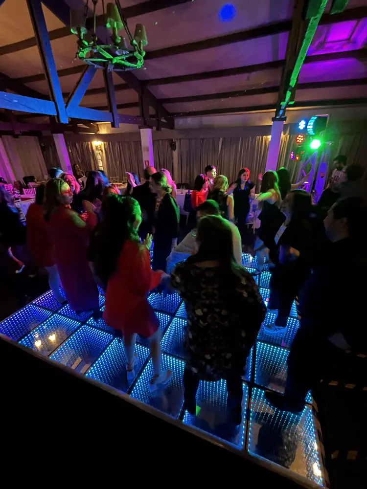 Invitados bailando sobre la Pista LED Infinity encendida en azul